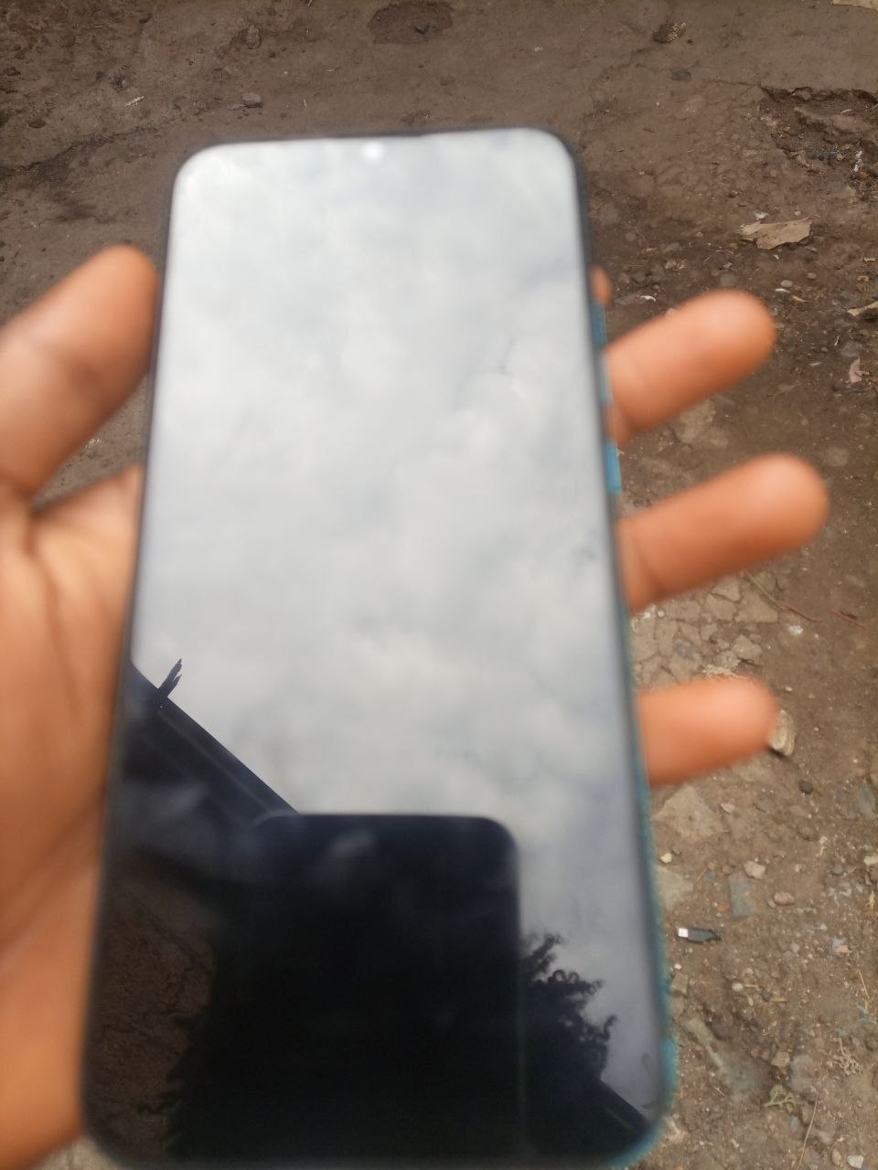 a person holding a cell phone in their hand
